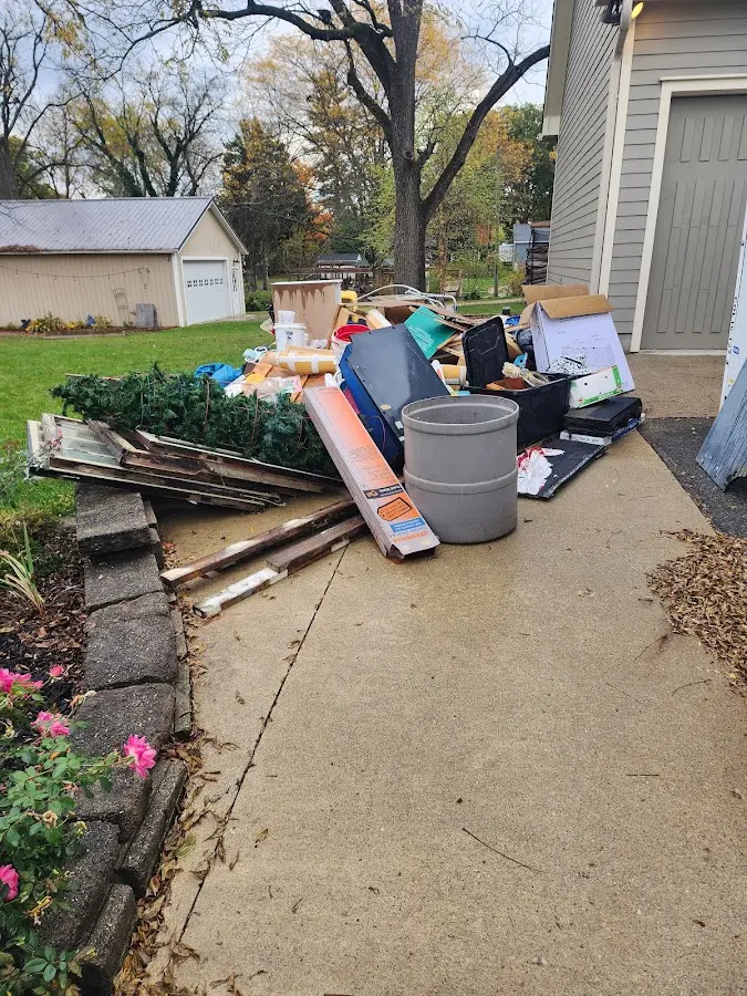 Dumpster being loaded with debris for Roofing Dumpster Rental in Huntingdon